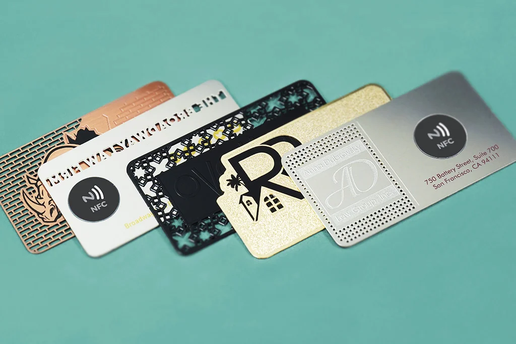 Product design examples: metal cards in several finishes with NFC symbols and cutout brand artwork